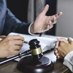 Judge and lawyer discussing civil dispute case in courtroom - Lusby Law P.A